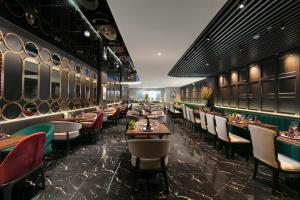 a restaurant with tables and chairs in a room at MAY DE VILLE Crown Hotel in Hanoi +98 photos