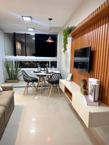 a living room with a couch and a table at Apartamento completo, próx às praias in Ôlho dʼÁgua