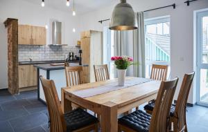 a kitchen and dining room with a wooden table and chairs at Pet Friendly Apartment In Attendorn in Attendorn