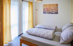 a room with two pillows on a bench with a window at Pet Friendly Apartment In Attendorn in Attendorn +12 photos