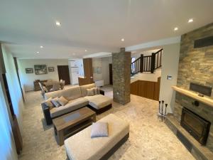 a living room with a couch and a fireplace at Къща за гости Лъките in Divchovoto