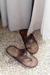 a pair of sandals are sitting on a floor at ARTOTEL Haniman Ubud in Ubud
