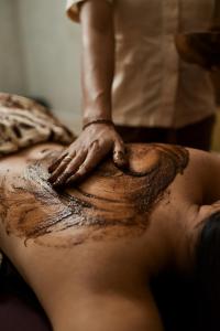 a woman getting a back tattoo on her back at ARTOTEL Haniman Ubud in Ubud
