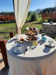 a white table with food on top of it at Cabaña Emmanuel in Santa Rosa de Calamuchita