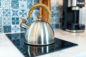a silver tea kettle sitting on a kitchen counter at The Spruce Villa where luxury meets nature in Panther Creek