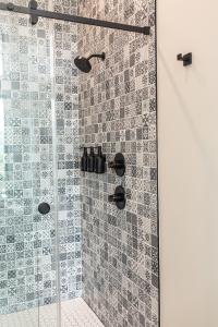 a bathroom with a shower with a glass door at The Spruce Villa where luxury meets nature in Panther Creek