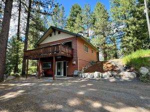 a small house with a deck in the woods at The Park Chalet by Casago McCall - Donerightmanagement in McCall