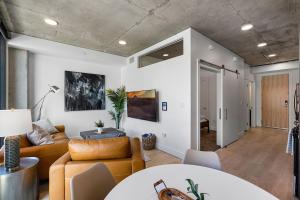 a living room with a couch and a table at 8th fl Amazing views! Lux design! Pool gym Pkg! in Salt Lake City +44 photos