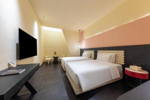 Voodi või voodid majutusasutuse LIKTO-YIYU Hotel Guangzhou Pazhou Exhibition Canton Tower Branch toas