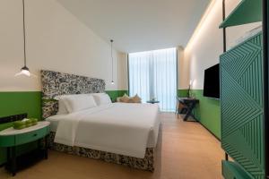 Voodi või voodid majutusasutuse LIKTO-YIYU Hotel Guangzhou Pazhou Exhibition Canton Tower Branch toas