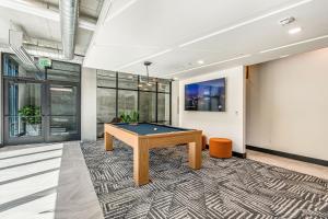 a billiard room with a pool table on a rug at 8th fl Amazing views! Lux design! Pool gym Pkg! in Salt Lake City