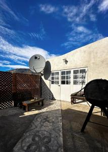 a building with a table and a satellite at Departamento con una vista exclusiva! in El Calafate