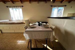 a dining room with a table and a bed at Departamento con una vista exclusiva! in El Calafate +12 photos