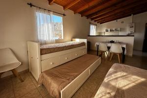 a bedroom with two bunk beds and a table at Departamento con una vista exclusiva! in El Calafate