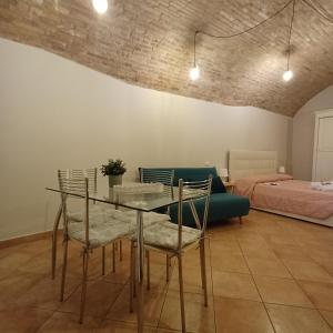 a living room with a table and chairs and a bed at Loft Gioia in Perugia