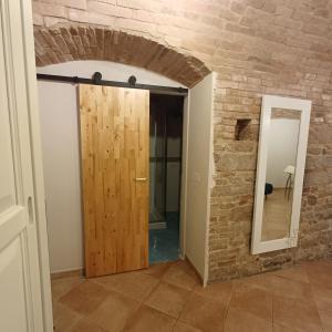 a door in a room with a brick wall at Loft Gioia in Perugia
