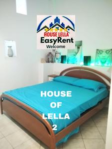 a bed in a room with a houseille easy rent welcome sign at "HOUSE OF LELLA 2" appartamento 1 camera da letto - M1 METRO ROSSA in Milan