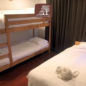 two bunk beds in a room with towels on a bed at Bann Jasmine Khaoyai in Mu Si