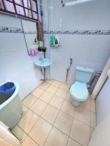 a bathroom with a toilet and a sink at Lenggong GEM 16 Homestay in Kampong Ulu Jepai