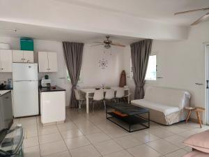 a kitchen and a living room with a couch and a table at Efterpis12 St. House in Paralimni