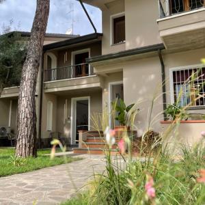 a house with a tree in front of it at La Bomboniera in Cervia