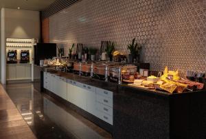 a buffet line in a restaurant with food on it at Mercure Tallinn in Tallinn