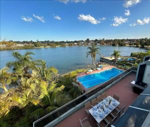 a view of the water from the balcony of a resort at Chiswick Waterfront Retreat in Sydney