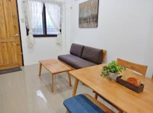 een woonkamer met een bank en een tafel bij Ann's Guesthouse in Butuan