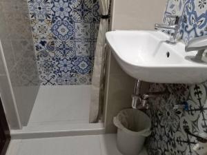 een badkamer met een wastafel en een douche bij Ann's Guesthouse in Butuan