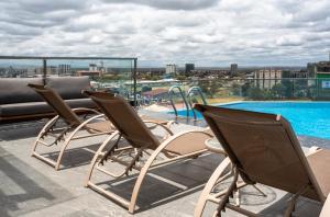 a group of chairs sitting on top of a roof at Okash City Boutique Hotel-Nairobi in Nairobi