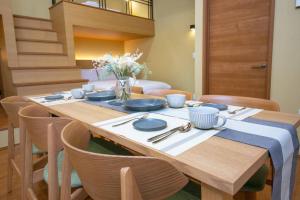 a dining room table with blue dishes on it at T-home彩 in Tokyo