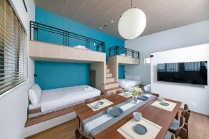 a room with a dining table and a bed and a loft at T-home彩 in Tokyo