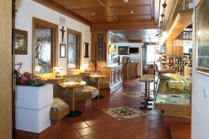 a lobby of a store with tables and chairs at Park Hotel Arnica in Falcade