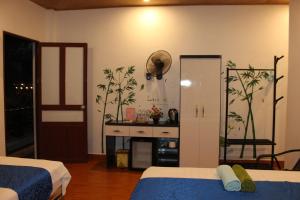 een slaapkamer met 2 bedden en een tafel en een deur bij Khai Yen Tam Coc Hostel in Ninh Binh