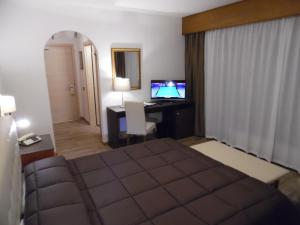 Postel nebo postele na pokoji v ubytování Hotel Trento