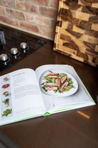 a book sitting on a table with a plate of food at Pulaski Point Properties in Chicago +135 photos