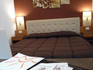 Postel nebo postele na pokoji v ubytování Hotel Trento