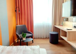 TV a/nebo společenská místnost v ubytování Heinrich Pesch Hotel