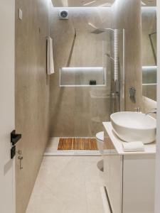 a bathroom with a sink and a toilet and a shower at illys central apartments in Ioannina +43 photos