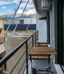 a balcony with a table and a chair at illys central apartments in Ioannina