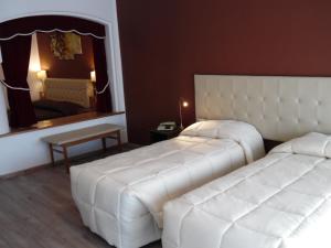 Postel nebo postele na pokoji v ubytování Hotel Trento