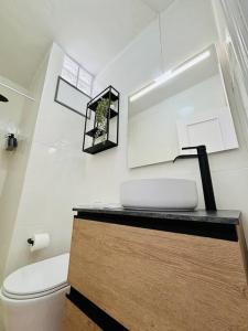 a bathroom with a white toilet and a sink at La Casa de Eloisa in Santa Cruz de Tenerife +25 photos