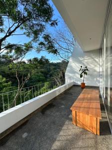 a room with a wooden table on a balcony at Rumah Lawani in Bandung