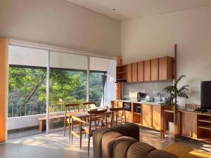 a kitchen and living room with a table and chairs at Rumah Lawani in Bandung