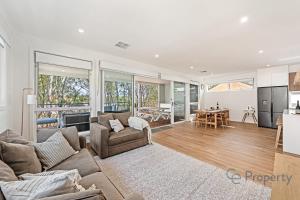a living room with a couch and a table at 'Laguna Haus' in Walker Flat