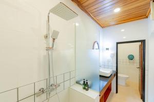 a bathroom with a shower with a glass door at Merry Riverside Hotel in Luang Prabang +58 photos