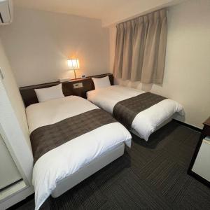 Postel nebo postele na pokoji v ubytování Takatsuki W and M Hotel