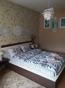 a bedroom with a bed with a white comforter at Apartment Ventuno 21 in Sliven