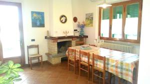 a dining room with a table and a fireplace at Villa In Lucca in Lucca