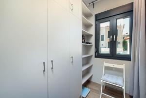 a room with white cabinets and a window at Citrus Residence in Mytilini +20 photos